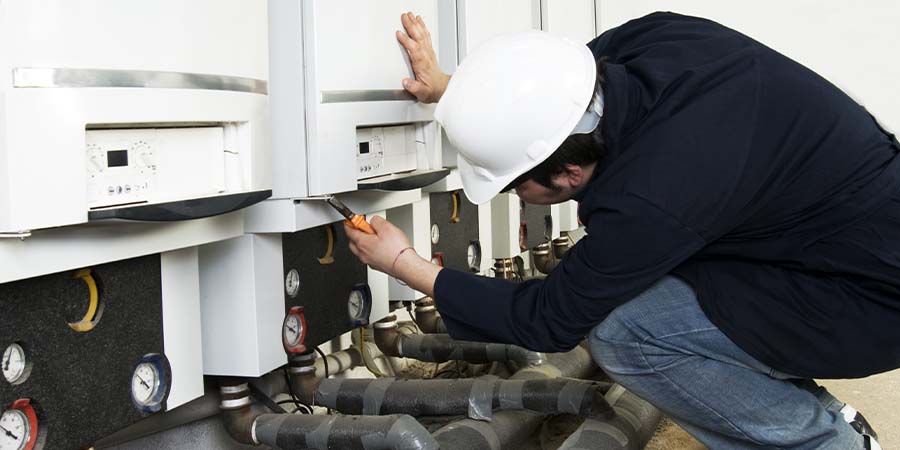 Service technician adjusting water heaters